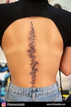 the back of a woman's lower back tattoo