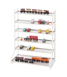 a toy train set is on display in a white shelve with multiple cars