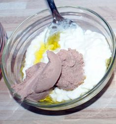 two spoons in a bowl with some food