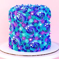 there is a blue and purple cake on the table