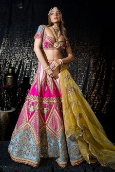 Rani pink flared lehenga with Bahar mahal embroidery using resham thread, zari, mirror highlights. Paired with a half sleeves deep sweetheart neck blouse with floral embroidery using resham thread, zari highlights, dangling glass beads and a contrasting yellow scallop border floral embroidered organza dupatta. - Aza Fashions Pink Lehenga With Gota Work, Pink Sharara For Navratri, Pink Anarkali Choli With Cutdana, Pink Sharara For Reception Navratri, Pink Sharara For Reception And Navratri, Designer Pink Lehenga With Cutdana Detail, Designer Pink Lehenga With Cutdana, Pink Dupatta For Navratri, Pink Anarkali Set With Gota Work For Reception