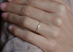 a woman's hand with a diamond ring on it