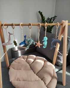 an infant's swing with toys hanging from it