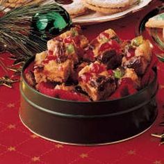 an assortment of food on a table with wine glasses and other holiday foods in the background