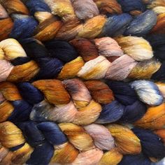 several skeins of multicolored yarn are stacked together on top of each other