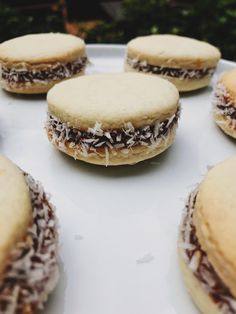 several cookies are arranged on a white plate