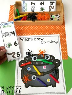 a hand is holding up a halloween counting game