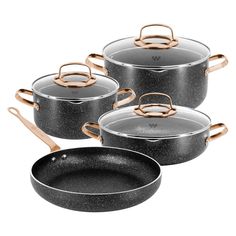 four pots and pans with copper handles on white background, one is black and the other is silver