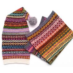 a knitted hat and scarf with a pom - pom on the side