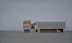 a large building sitting on top of a sandy beach