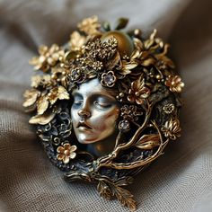 a close up of a face with flowers on it's head and gold leaves