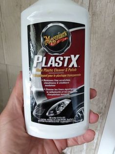 a hand holding a bottle of plastx cleaner