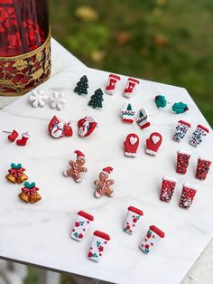 a table topped with lots of different types of christmas decorations next to a bottle of wine