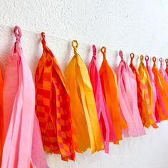 colorful tissue tassels hanging on a wall