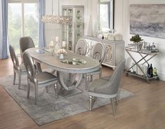 a dining room table and chairs in front of a mirror