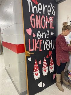 two women standing in front of a sign that says there's gnome one like you