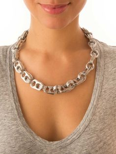 a woman wearing a silver chain necklace