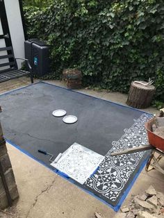 an outdoor area with cement and paint being laid on the ground to create a rug