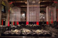 a banquet hall with tables and chairs set up for a formal function in the center