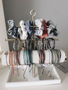 an assortment of bracelets and necklaces on display in front of a white door