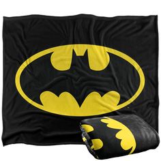 a batman blanket and pillow set on a white background