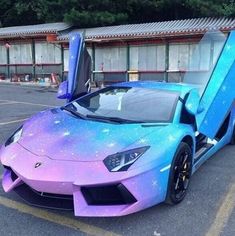 a purple and blue car parked in a parking lot