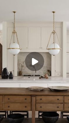 a kitchen island with two bowls on it and an overhead light hanging from the ceiling