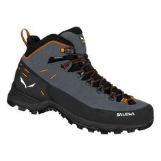 a pair of hiking shoes with orange laces on the outstep and black soles