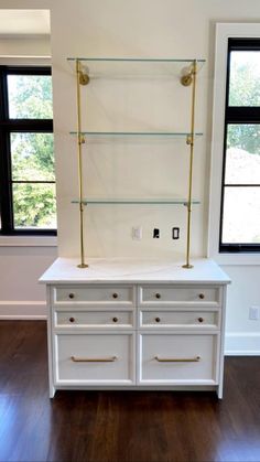 a white dresser with gold handles and drawers on it, next to a pink heart sticker