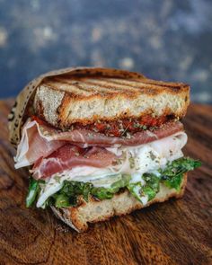 a close up of a sandwich on a wooden table