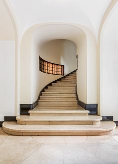 an arched staircase leading up to the second floor