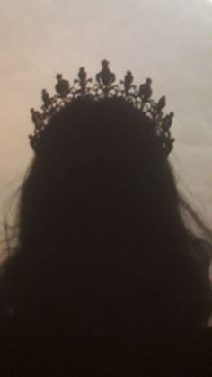 the silhouette of a woman with a crown on her head