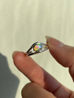 This ring features a beautiful Australian freeform crystal opal, with a unique pink base color. Even in cloudy conditions this opal GLOWS, see photos! Solid sterling silver handcrafted ring. Size 7.5 Modern Opal Ring For Anniversary, Modern Round Opal Ring, Handmade Open Opal Ring, Iridescent Opal Ring As A Gift, Iridescent Opal Ring As Gift, Iridescent Opal Ring Perfect For Gifts, Iridescent Opal Ring With Gemstone, Iridescent Opal Ring For Gift, Iridescent Opal Ring Gift