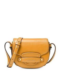 An equestrian-inspired design with all the right details. The Saddle Mini Crossbody features a take-anywhere silhouette with beautiful gold-tone studs and hardware.Mini sized bag; 7"W x 5"H x 2"D (width is measured across the bottom of handbag)21"L to 25"L strapMagnetic flap closureGold-tone exterior hardware & 1 back slip pocket1 interior zip pocket, 2 slip pockets & 3 credit card pocketsLeather; lining: suedeColor: Merigold Shoulder Bags Pattern, Brown Crossbody Bag, Michael Kors Crossbody Bag, Leather Saddle Bags, Brown Crossbody, Brown Shoulder Bag, Purse Styles, Michael Kors Collection, Black Crossbody