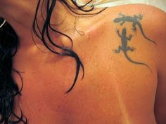 a man with a lizard tattoo on his back