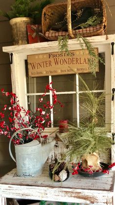 an old window is decorated with red berries and greenery for the winter wonderland display