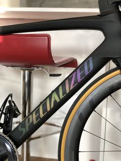 a bicycle with the word specialized painted on it's front tire and seat rest