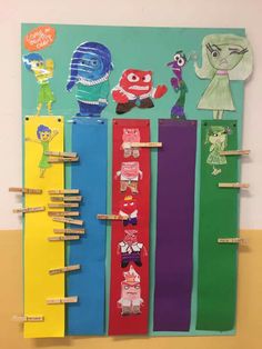 a group of children's bookmarks with cartoon characters on them hanging from clothes pins