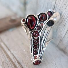 Amir Poran Design------A long finger ring  with  GARNET  stones and 3 CZ( garnet) Description Length--1.57 inches Max width--1.18 inches Matching bracelet: https://www.etsy.com/il-en/listing/1091372619/silver-big-cuff-bracelet-multi-stone?click_key=8237349103ec7740c3e2d52ca3a95c0572d66335%3A1091372619&click_sum=daf6f63d&ref=shop_home_active_31&pro=1&frs=1&sts=1 An amazing gift for yourself or loved ones!  Comes in a beautiful jewelry gift box.  For more information see our shop policies.  Got an Silver Garnet Rings With Spiritual Style, Silver Spiritual Garnet Rings, Spiritual Silver Rings With Garnet, Spiritual Silver Garnet Rings, Unique Silver Garnet Rings, Silver Ring Set, Garnet Ring, Garnet Stone, Matching Bracelet