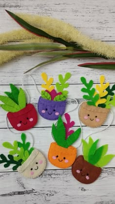 felt fruits and vegetables are hanging on a string