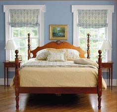 a wooden bed sitting on top of a hard wood floor