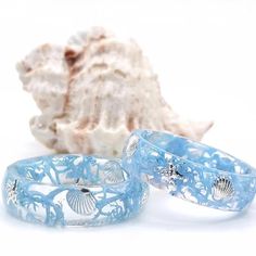 Ocean seashell & starfish ring  Resin ring with silver shell inlay. The color blue of the resin ring symbolizes love, inspiration and wisdom. Blue is the most pleasing color for the human eye, plus it embodies the powers of nature like nothing else. The oceans a calm presence and sense of space, a place to reflect on the past, and to dream and hope about the future. The ocean is a powerful symbol. Throughout history, it has been seen as a symbol of power and strength. Today, it is often seen as a symbol of mystery, endlessness, calmness, hope, and even truth. These rings are perfect for people that love natural & oceanic styles.  I offer Sizes 4-16. Choose your size from the size options above.  Each piece in my shop are handmade by me. They are each unique and different, no piece can be r Ocean-inspired Promise Ring, Beach Summer Jewelry Ring, Summer Beach Jewelry Ring, Summer Beach Ring Jewelry, Light Blue Ocean-inspired Jewelry For Gift, Blue Resin Jewelry For Summer, Ocean-inspired Light Blue Jewelry For Gift, Light Blue Ocean-inspired Jewelry Gift, Ocean-inspired Shell-shaped Rings As Gift