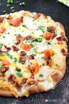 a pizza sitting on top of a pan covered in cheese and toppings