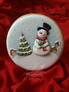 a christmas ornament with a snowman holding a gift