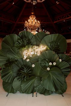 a large green plant with the words buffet together on it's backlit sign