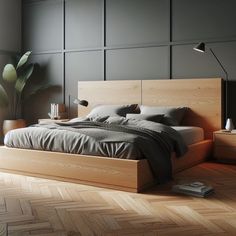 a bed sitting on top of a wooden floor next to a plant in a bedroom