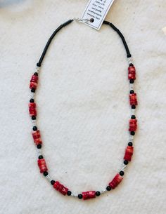 20-12. Red and black always seem to make an outfit more dramatic! Silver tone spacer beads give a little glitter to this necklace. Coral heishi shaped beads give an interesting texture to this necklace, and onyx is my go-to accent stone. The clasp is sterling silver. Red Heishi Beads Necklace For Gift, Handmade Red Heishi Beads Necklace, Red Heishi Bead Necklaces, Red Heishi Beads Beaded Necklace, Black Heishi Beads Necklace For Gift, Red Heishi Beads, 20 Inch Necklace, Spacer Beads, Onyx