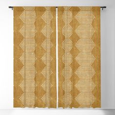 an orange and white curtain hanging on a wall