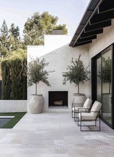 an outdoor patio with chairs and a fire place