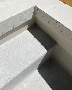 a concrete bench sitting on top of a sidewalk